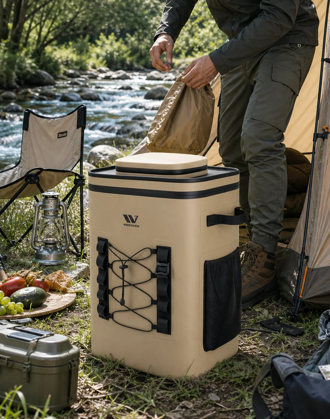 Camper opening a cooler beside a tent, with carrying handles and external pockets visible